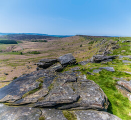 A view over millstone slabs on top of the Stanage Edge escarpment in the Peak District, UK in summertime