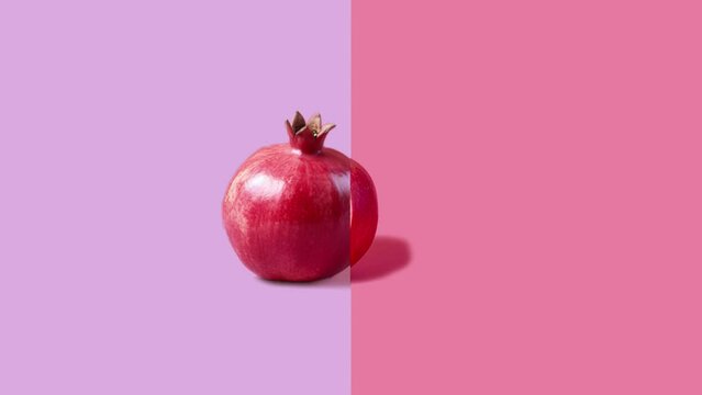 Stop motion Cut and whole Pomegranate appear and disappear on pastel background. High quality video 4K. Detailed stop motion video. Background or wallpaper in food and drinks videos.