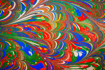 Ebru art. Traditional Turkish Ebru technique. Painting on water, followed by paper prints. Color paint ebru with waves and tile pattern.