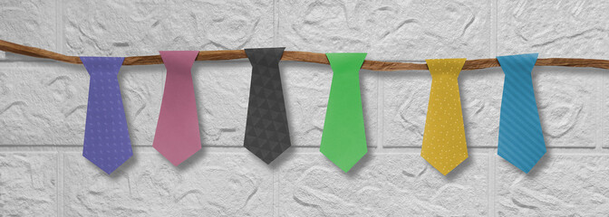 Banner with garland for Father's Day, birthday, bachelor party, anniversary. Ties cut out of paper on rope on white brick wall background. Preparation for holiday. Header for website, blog, article.