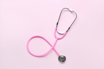 Modern stethoscope on  pink background