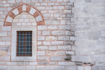 Fototapeta na wymiar Window on a brick wall under brick arch.