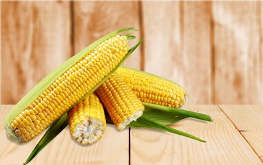 Fresh tasty ripe yellow corn on desk