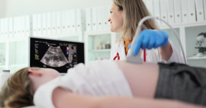 Doctor conducting ultrasound examination of internal organs of child in clinic. Diagnosis and treatment of diseases of liver and biliary tract in children