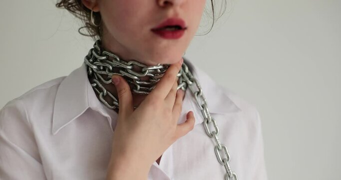 Sick upset girl touching neck with chain. Woman suffering from sore throat