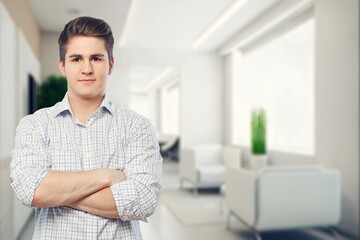Fototapeta premium Handsome young smart man with arms crossed