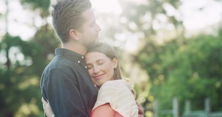 Park, love and couple hug with sunshine for bonding, romance and loving affection outdoors. Relationship, dating and happy man and woman embrace in nature for quality time, intimacy and commitment