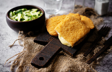 Cordon blue with cheese and cucumber salad