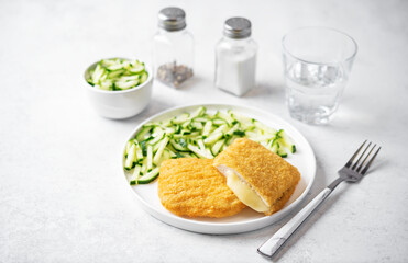 Cordon blue with cheese and cucumber salad