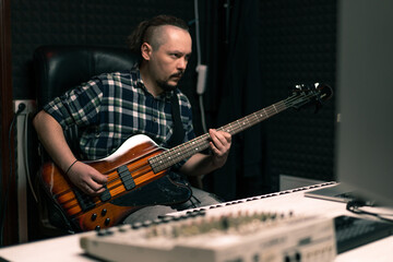 Obraz premium rock performer with electric guitar in recording studio recording playing own track musical instrument strings melody