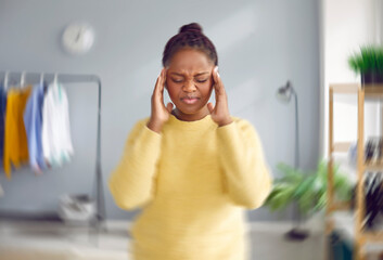 Sick, dizzy, young woman suffering from vertigo, headache. Portrait of attractive stressed African...