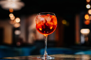 alcoholic cocktail in a glass stands on a table in a bar or restaurant