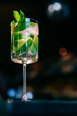 alcoholic cocktail in a glass stands on a table in a bar or restaurant