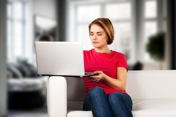 Beautiful happy woman use laptop computer at home