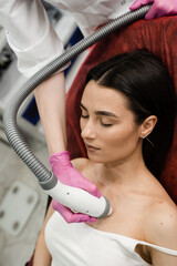 Tightening and rejuvenation of facial skin of girl at cosmetology procedure. Thermal or radio...