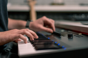 Obraz na płótnie Canvas professional recording studio sound engineer or music producer musician pressing synthesizer keys
