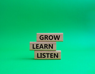 Grow Learn Listen symbol. Concept words Grow Learn Listen on wooden blocks. Beautiful green background. Business and Grow Learn Listen concept. Copy space