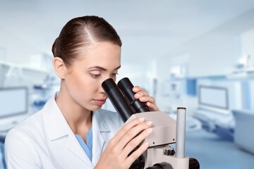 Young smart scientist with a microscope in the laboratory.