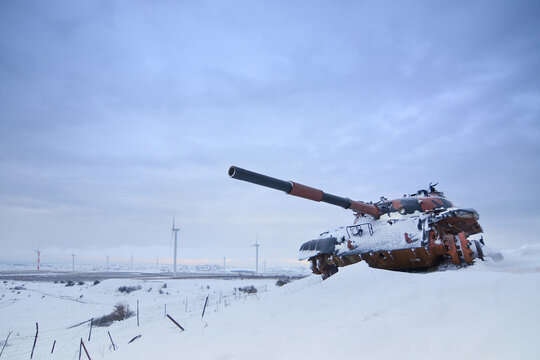 Tank and a wind farm on a cold snowy morning