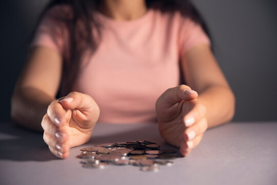 women holding a coins and press calkulator