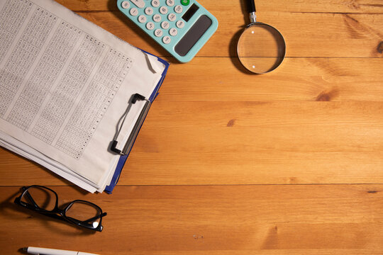 wooden desktop with dokument and book