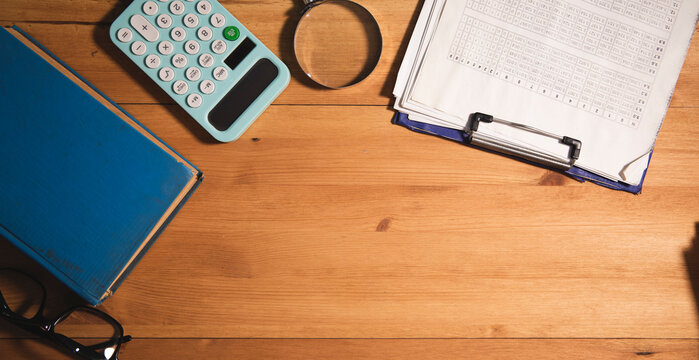 wooden desktop with dokument and book