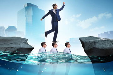Inequal competition concept with businessman walking on heads