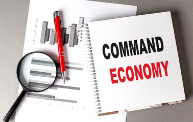 COMMAND ECONOMY text written on notebook with chart