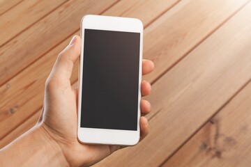 Human hand hold a smartphone with blank screen