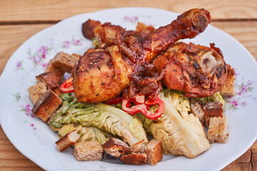 Close up picture of tasty and juicy sweet and spicy grilled chicken drumsticks on fresh lettuce salad with miso dressing and bread crumbs, light, healthy and balanced diet food, full of nutritions.