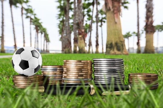 football ball and gold coins, online betting concept