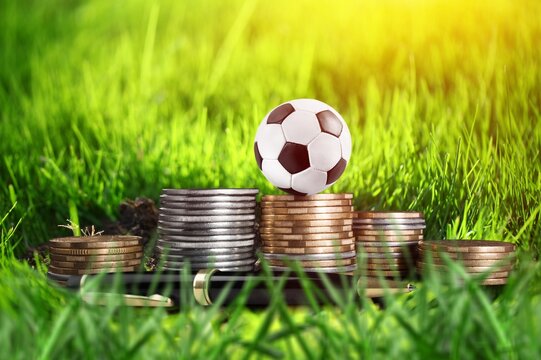 football ball and gold coins, online betting concept