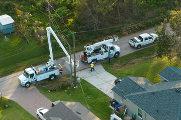 Aerial view of electrician workers repairing damaged power lines after hurricane Ian in Florida...