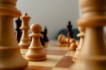 opening in chess. creative chess photo. close photo to a pawn chess piece. Focus on. Fallen pieces