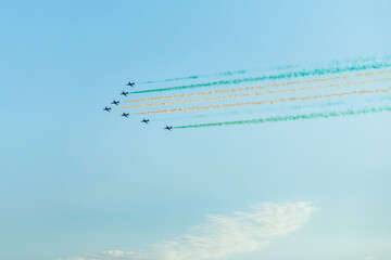 Fighter jets squadron with traces in Saudi Arabian national flag colors, at Jeddah air show - obrazy, fototapety, plakaty