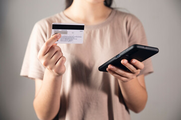 women holding a phone and bank cart