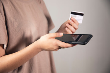 women holding a phone and bank cart