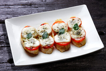 bruschetta with tomato, mozzarella, basil