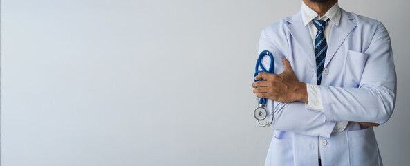 male doctor wearing white long-sleeved medical uniform with heart rate monitor. medical file stand...