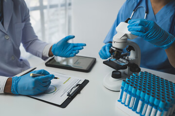 medical research laboratory Team of scientists or doctors using digital tablets analyzing advanced...