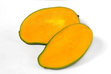 Sliced fresh juicy mango layed down on white, yellow organic exotic healthy fruit