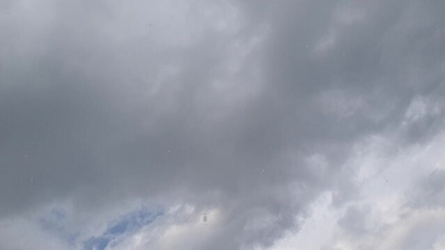 Timelapse of clouds in an overcast sky and it starts to rain