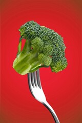 Tasty ripe green broccoli on fork