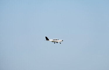 Fototapeta na wymiar Private jet in action in the sky. Landing and take off.