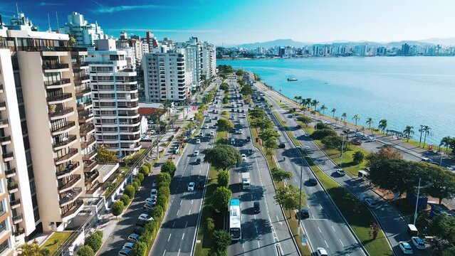 Aerial view of the city of Florianopolis and its coastal highway during sunny day. Santa Catarina state in Brazil