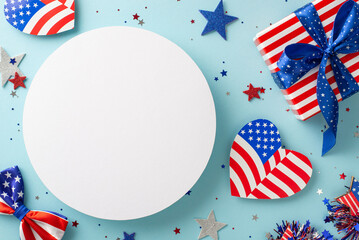 Obraz premium USA National Day commemoration. Top view of symbolic adornments: hearts with flag pattern, stars, confetti, themed giftbox, bow-tie, placed on pastel blue backdrop with unfilled circle for text or ad