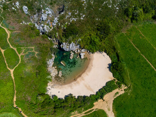 Aerial view, Playa de Gulpiyuri, flooded sinkhole with inland beach near Llanes, in Asturias Northern Spain, around 100 m from Cantabrian Sea, the shortest beach in the world