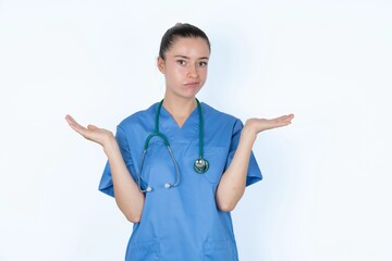 Careless attractive young caucasian doctor woman wearing medical uniform over white background...