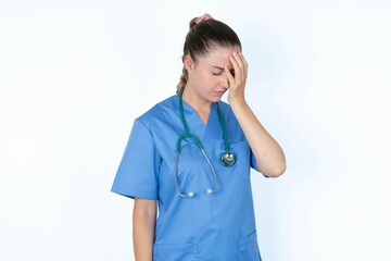 young caucasian doctor woman wearing medical uniform over white background with sad expression...