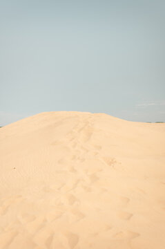 Footprints On a Sand Dune, Beige Sand Desert Texture Background Photo